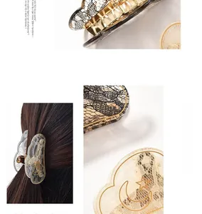 Detail view of acrylic lace hair clips with gold moon and star accents in cloud shape