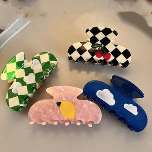 Checkerboard pattern hair claw clips with cherry and heart motifs in various colors