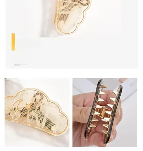 Detailed macro view of the romantic cloud-shaped hair claw with lace and gold star moon elements