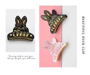 Macro detail of bunny hair clips in black and white with cute heart patterns