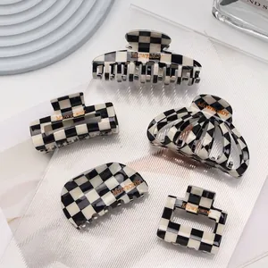 Checkerboard pattern acetic acid hair claws in black and white minimalist style