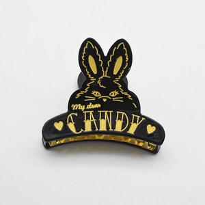 Cute black acetate bunny hair claw clip with gold rabbit outline and decorative text