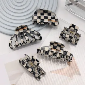 Detailed set of black and white checkerboard hair claws in various geometric shapes