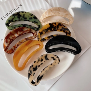 Elegant large acetate crescent hair claws in assorted marble and tortoise patterns