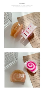 Detailed macro view of acetate hair claws with orange texture and pink spiral patterns
