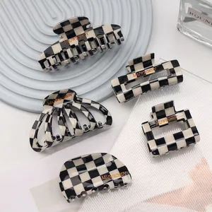 Five geometric black and white checkerboard hair claws in various shapes for women