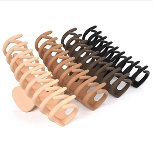 Set of four large matte hair claw clips in earth tones including beige brown and black