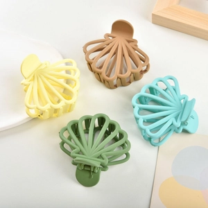Set of four shell-shaped matte hair claws in muted candy colors for women's hair styling
