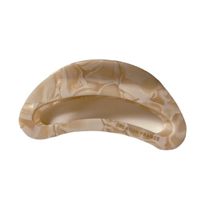 Elegant cutout acetate hair claw with cream marble pattern and curved shark clip design