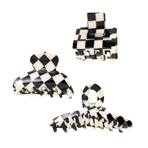 Three black and white checkerboard hair claws in square, half-moon and bar shapes