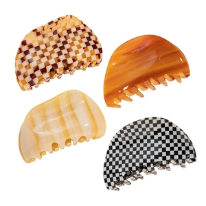 Set of four tortoiseshell and checkerboard patterned acetate hair claws on white background