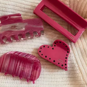 Pink and purple acetate hair claw clips with marble and polka dot patterns in French style