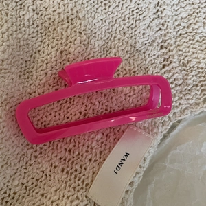 Macro detail of pink cellulose acetate hair claw clip with France Handmade gold lettering