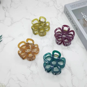 Floral hair claw clips in translucent jelly colors for women on marble background