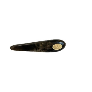 Vintage tortoiseshell acetate hair clip with an oval gold metal logo plate detail