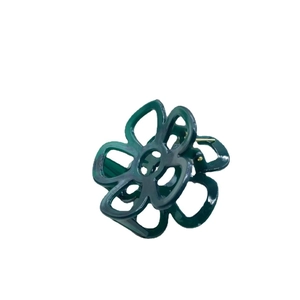 Elegant dark green flower hair claw clip in glossy resin finish on white background