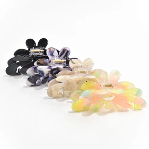 Set of four floral acetate hair claws in black, marble blue, tortoiseshell and rainbow colors
