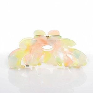 Detail view of flower hair claw clip with colorful acetate gradient and marble texture