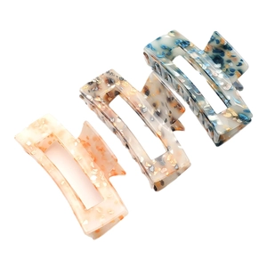 Three large acrylic hair claws with colorful marble texture for women hair styling