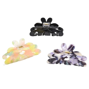 Three-piece acetate flower hair claw clips in black, colorful marble, and purple patterns