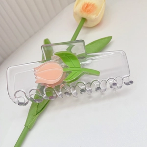 Vue détaillée d'une pince à cheveux transparente ornée d'un motif de tulipe rose