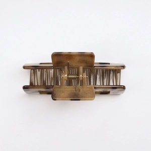 Close-up of tortoise shell pattern square hair claw with strong metal spring detail