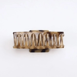 Detail shot of rectangular tortoiseshell hair claw clip with leopard pattern and metal spring