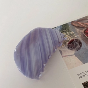 Close-up of purple striped acetate hair claw clip with a glossy translucent finish