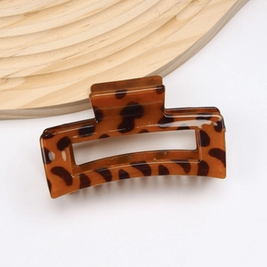 Macro view of rectangular tortoise shell hair claw clip with amber brown textures