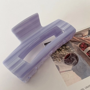 Elegant purple acetate hair claw clip with marble texture for a stylish French updo