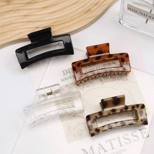Set of four minimalist rectangular hair claws in black, tortoise shell, and clear finish