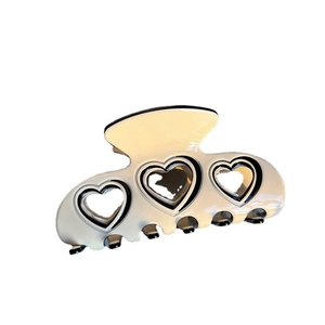 Elegant cream acetate hair claw clip with hollow heart design and black contrast trim