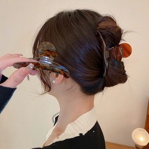 Classic tortoiseshell hair claws in light and dark amber patterns on hair