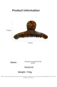 Detail view of acetate claw clip with amber texture and 9.7cm x 4.5cm dimensions
