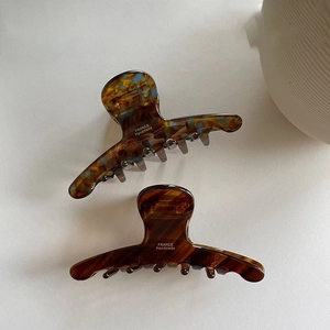 Detail of handmade tortoiseshell acetate claw clips with France minimalist design