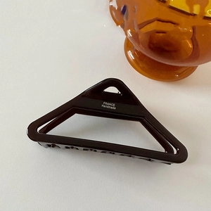 Detail of hollow triangle hair claw with polished finish and France Handmade mark