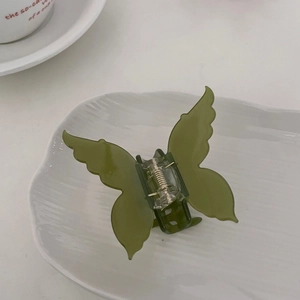 Detail of avocado green butterfly hair claw clip with transparent acetate and metal spring