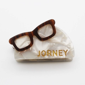 Chic acetate hair claw clip in eyeglass shape with marble texture and JORNEY lettering
