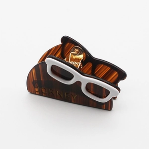 Chic tortoiseshell acetate hair claw with white sunglasses design and JORNEY lettering