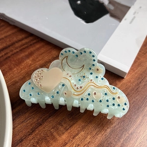 Detail der hellgrünen Acetat-Haarklammer in Wolkenform mit Strass und Mondmuster