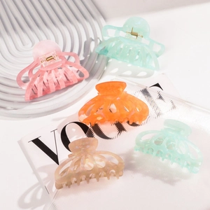 Set of five colorful matte acetate claw clips in pastel pink, blue, and green for hair styling