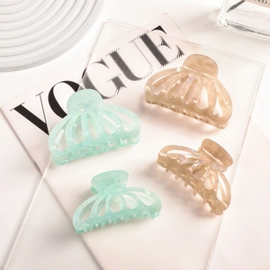 Set of four tortoiseshell acetate pumpkin hair claws in mint green and champagne colors