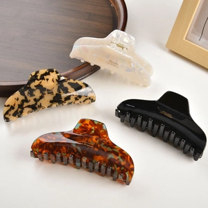Set of four vintage acetate hair claws in pearl white, leopard, black and tortoiseshell