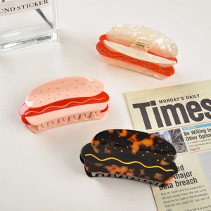 Three-piece acetate hot dog hair claw clips in tortoiseshell, pink, and marble white