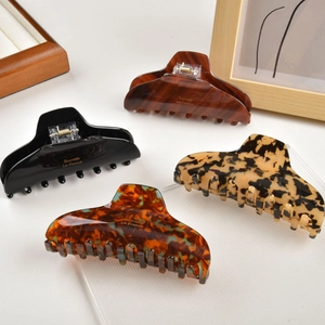 Set of four tortoiseshell and solid acetate hair claws with gold Barrette La France text