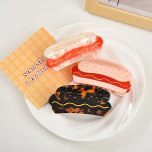 Three-piece set of hot dog shaped acetate hair claws in warm tortoiseshell and solid tones