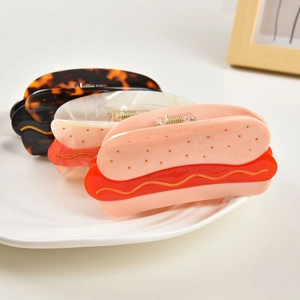 Detailed view of creative food-shaped hair claws with resin texture and metal springs