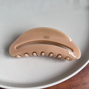 Detailed view of large hollow acetate hair claw clip with France Handmade lettering