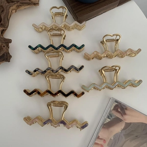 Set of wavy acetate hair claws in various vintage marble patterns and metallic finishes