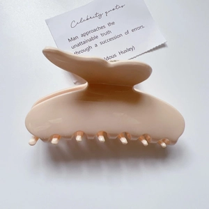 Detail einer großen Schmetterlings-Haarklammer aus zartrosa Acetat mit Hochglanz-Finish